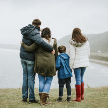 Parents with their children looking at the ocean
